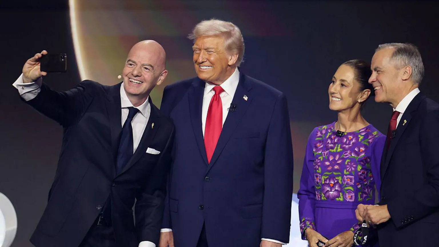 Getty Images Gianni Infantino takes a selfie with Donald Trump, Claudia Sheinbaum and Mark Carney